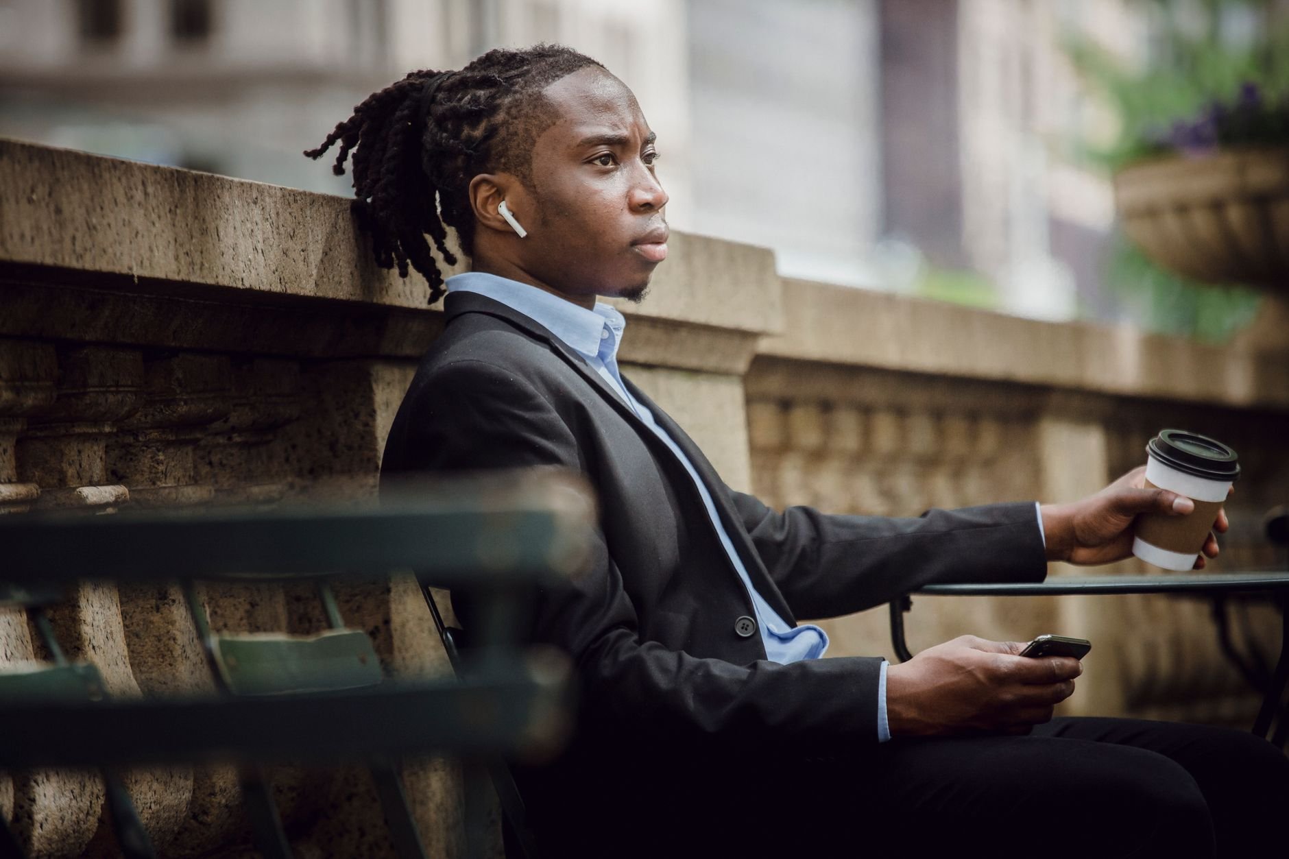 Young professional with wireless earphones enjoying music on commute